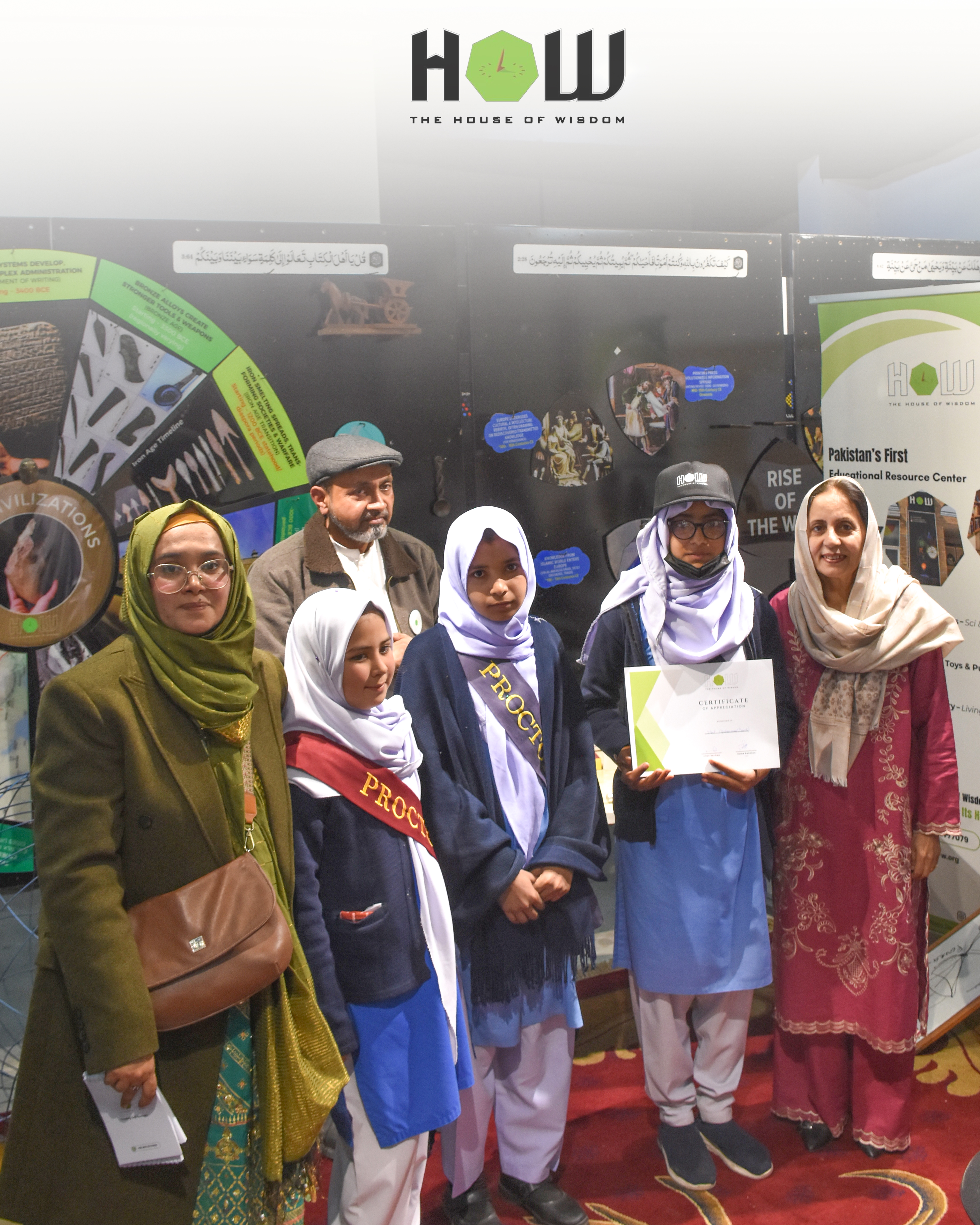 Bright — students posing with their sun/solar-themed exhibit, wearing sashes