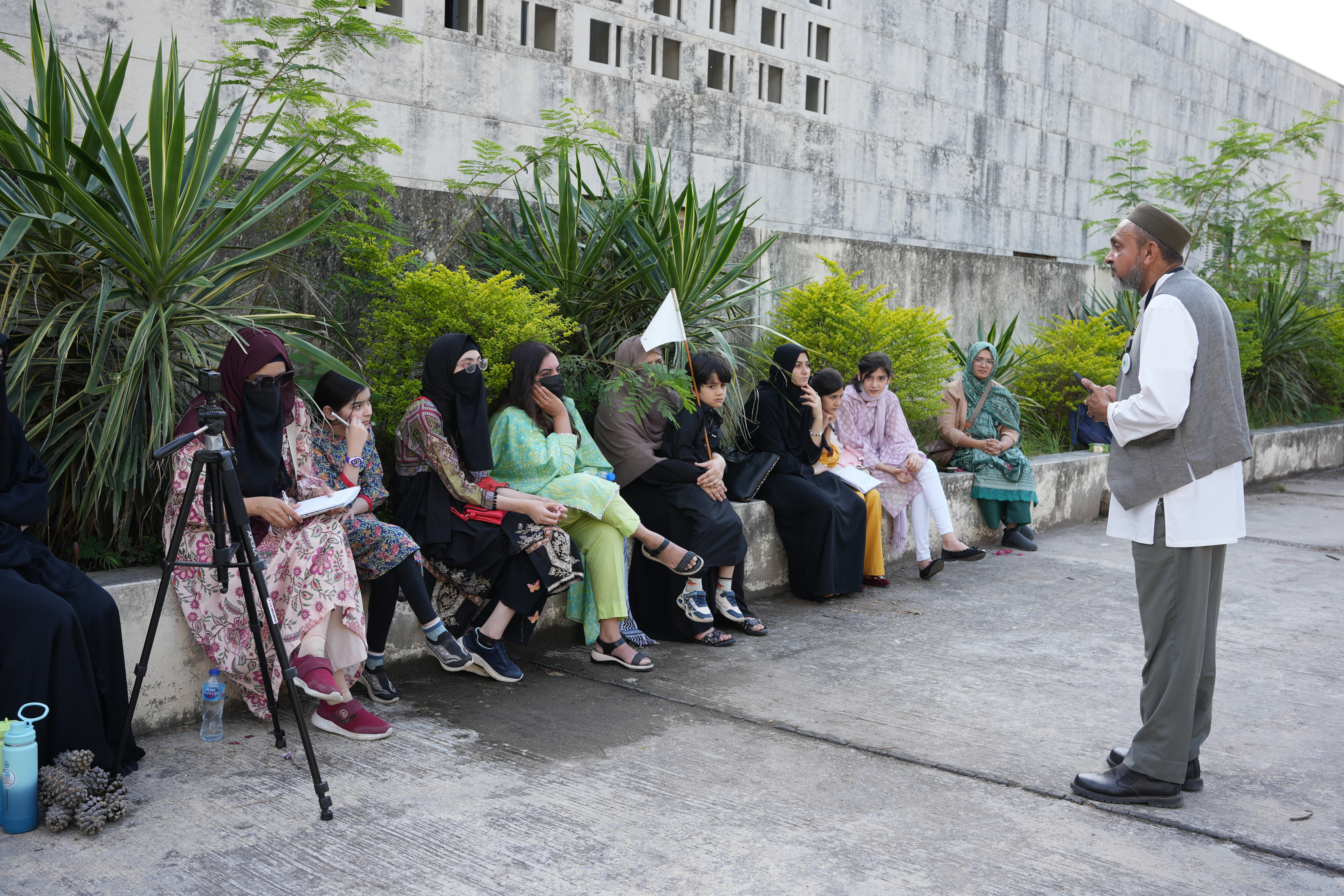 Courtyard Briefing — Wide perspective of the outdoor briefing before exploring the monument's historical galleries.