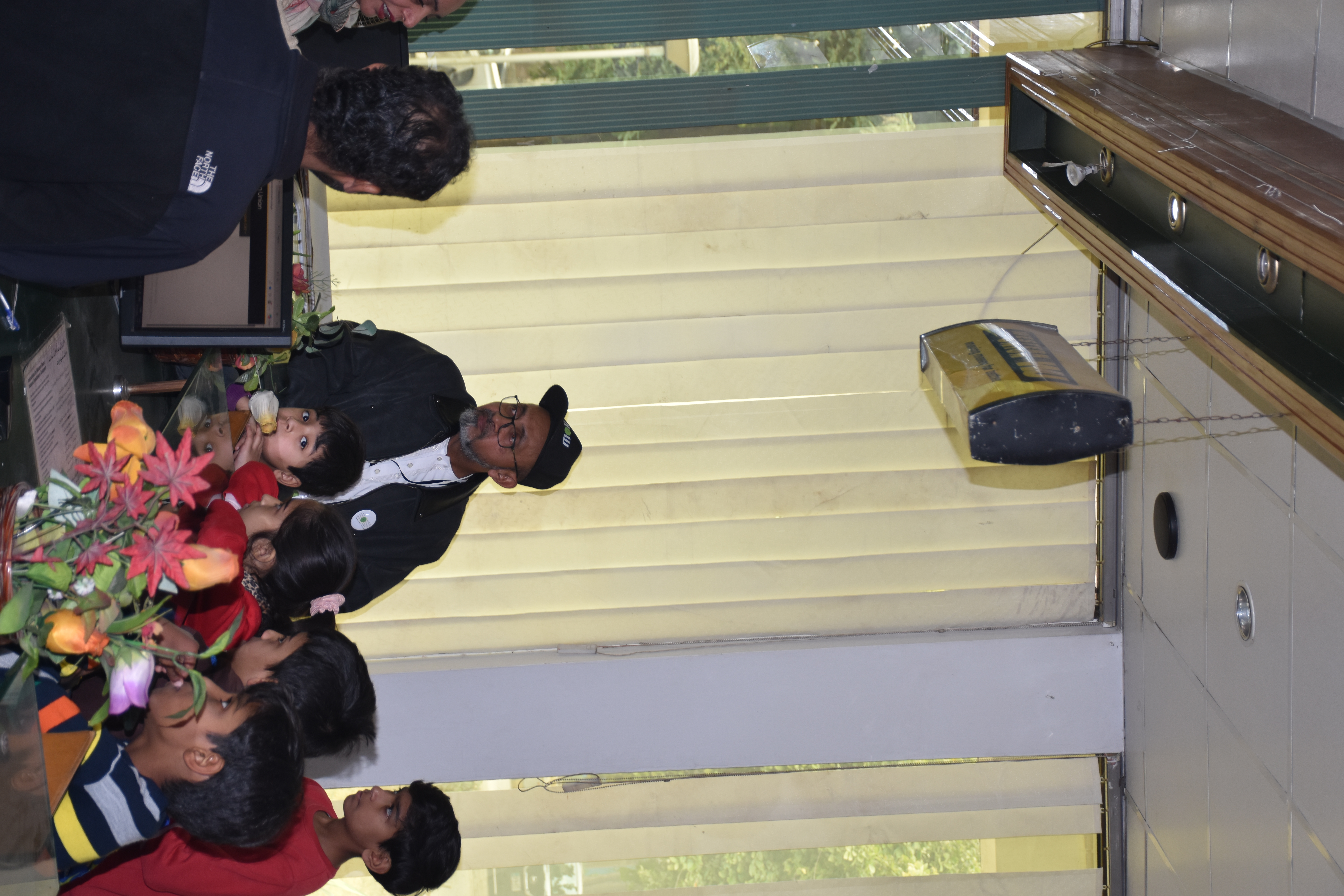 Reflection — Flowers on the table, curiosity in the room. It is a quiet pause to reflect on the visit.
